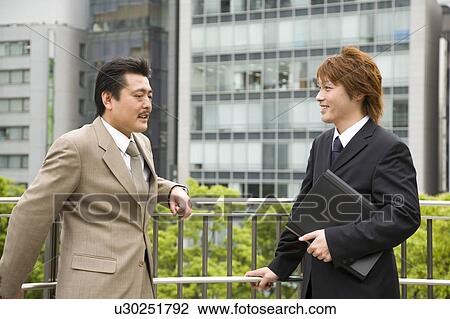 Two businessmen talking View Large Photo Image Stock Image - Two businessmen talking. Fotosearch