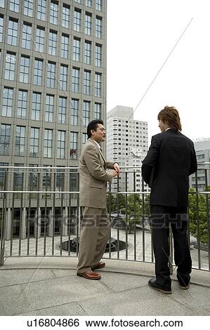 Two businessmen talking View Large Photo Image Stock Photograph - Two businessmen talking. Fotosearch