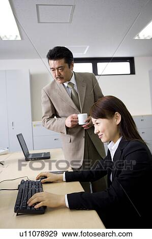 Two people working in office View Large Photo Image Stock Photo - Two people working in office. Fotosearch