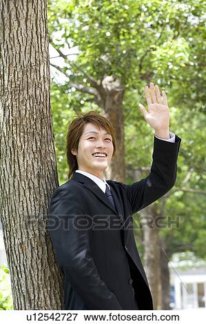 Young businessman waving hand View Large Photo Image Stock Photo - Young businessman waving hand. Fotosearch