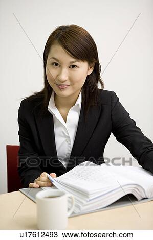 Young businesswoman sitting in meeting room View Large Photo Image Stock Image - Young businesswoman sitting in meeting room. Fotosearch