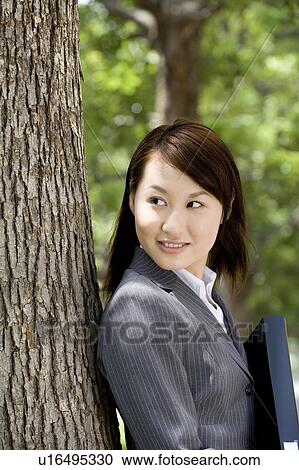 Young businesswoman standing outside View Large Photo Image Stock Image - Young businesswoman standing outside. Fotosearch