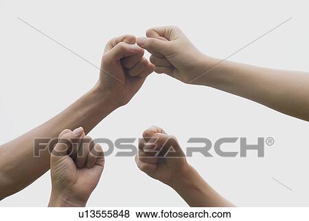 Stock Photo - Fists of four people. Fotosearch