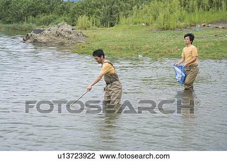 Two people cleaning river View Large Photo Image Stock Image - Two people cleaning river. Fotosearch