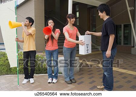 Young people asking donation View Large Photo Image Picture - Young people asking donation. Fotosearch