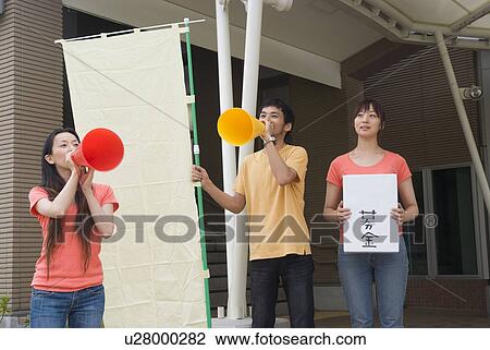 Stock Image - Young people asking donation. Fotosearch