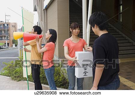 Stock Photo - Young people asking donation. Fotosearch
