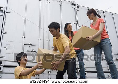 Picture - Young people carrying boxes. Fotosearch