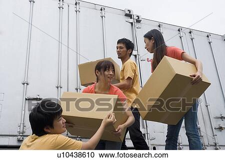 Young people carrying boxes View Large Photo Image Stock Image - Young people carrying boxes. Fotosearch