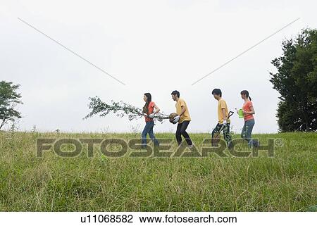 Young people carrying tree View Large Photo Image Stock Image - Young people carrying tree. Fotosearch