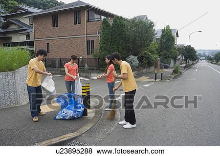 Young people cleaning garbage View Large Photo Image Stock Photo - Young people cleaning garbage. Fotosearch