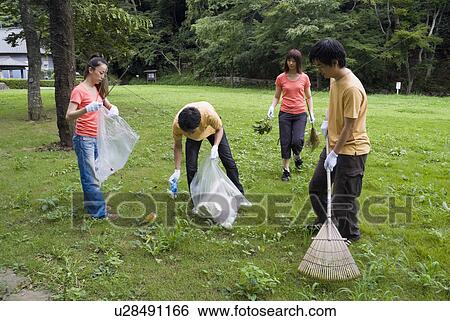 Stock Photograph - Young people cleaning park. Fotosearch