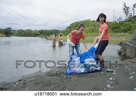 Young people cleaning river View Large Photo Image Stock Image - Young people cleaning river. Fotosearch