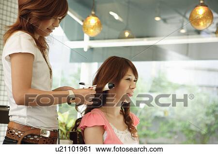 Hairdresser drying woman's hair View Large Photo Image Stock Image - Hairdresser drying woman's hair. Fotosearch