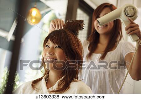 Hairdresser drying woman's hair View Large Photo Image Stock Photo - Hairdresser drying woman's hair. Fotosearch