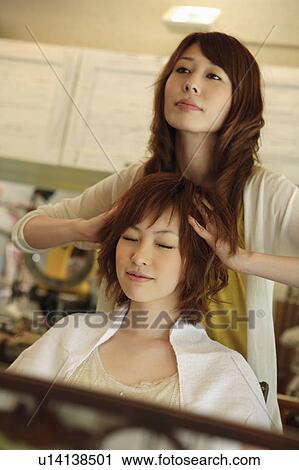 Hairdresser giving customer head massage View Large Photo Image Stock Image - Hairdresser giving customer head massage. Fotosearch