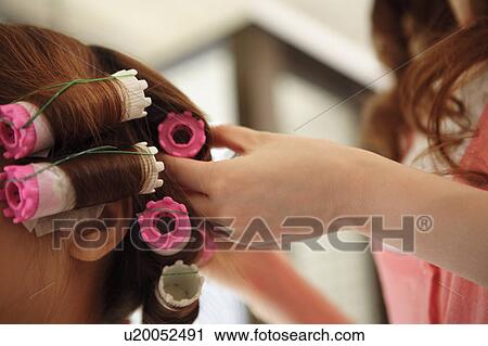 Hairdresser putting curlers in customer's hair View Large Photo Image Stock Image - Hairdresser putting curlers in customer's hair. Fotosearch