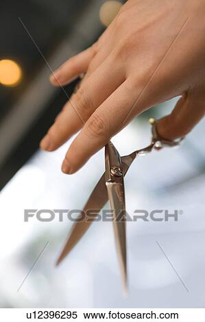 Hairdresser with scissors in hand View Large Photo Image Stock Photography - Hairdresser with scissors in hand. Fotosearch