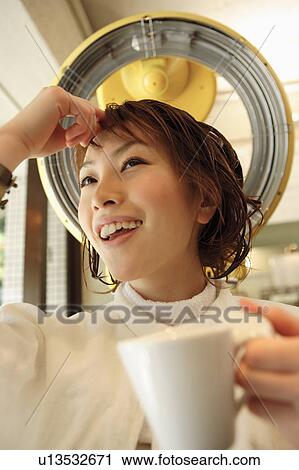 Young woman drinking coffee in hair salon View Large Photo Image Stock Image - Young woman drinking coffee in hair salon. Fotosearch
