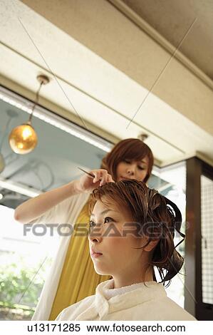 Young woman having hair dyed View Large Photo Image Stock Photography - Young woman having hair dyed. Fotosearch