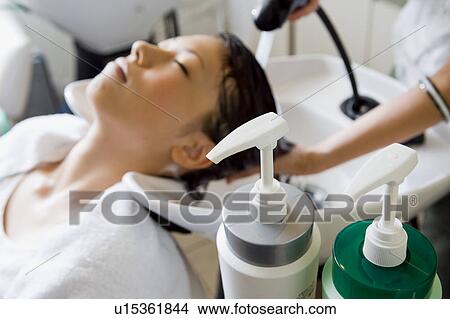 Young woman having hair washed View Large Photo Image Picture - Young woman having hair washed. Fotosearch