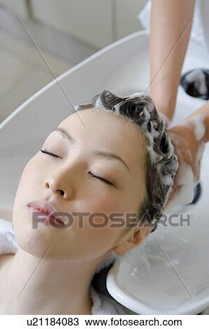 Young woman having hair washed View Large Photo Image Stock Image - Young woman having hair washed. Fotosearch