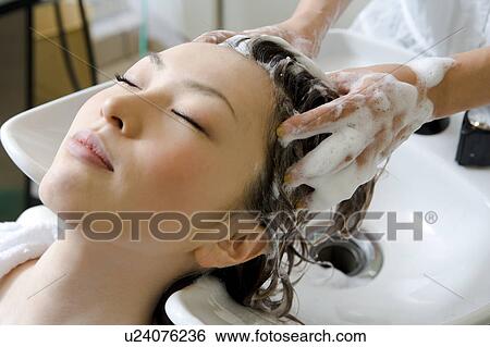 Young woman having hair washed View Large Photo Image Stock Photograph - Young woman having hair washed. Fotosearch
