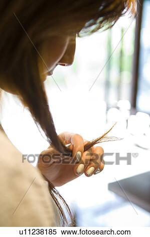 Young woman touching hair View Large Photo Image Stock Photography - Young woman touching hair. Fotosearch