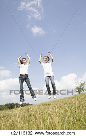 Stock Image - Girls jumping. Fotosearch