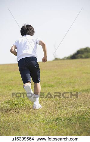 Picture - One schoolboy running, rear view. Fotosearch
