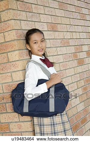 Portrait of schoolgirl standing View Large Photo Image Picture - Portrait of schoolgirl standing. Fotosearch
