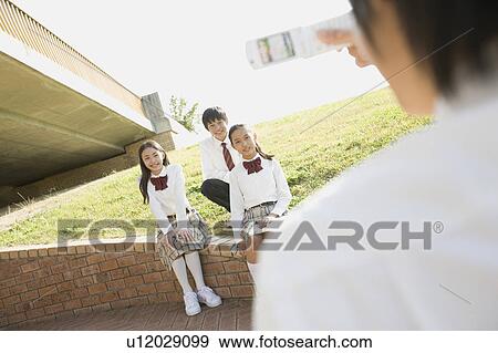 Stock Photo - School children photographing. Fotosearch