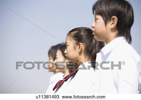 School children standing in a row View Large Photo Image Stock Image - School children standing in a row. Fotosearch