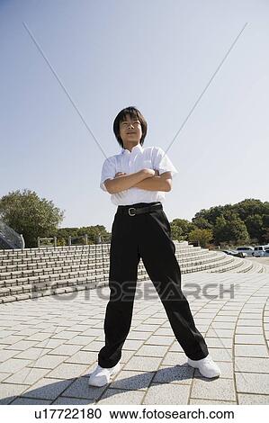 Schoolboy standing with arms crossed View Large Photo Image Stock Image - Schoolboy standing with arms crossed. Fotosearch