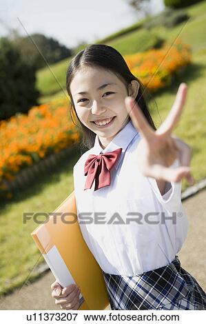 Schoolgirl holding file View Large Photo Image Stock Photo - Schoolgirl holding file. Fotosearch