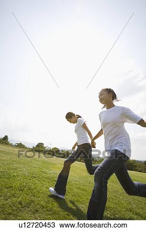 Two girls running in park View Large Photo Image Stock Image - Two girls running in park. Fotosearch