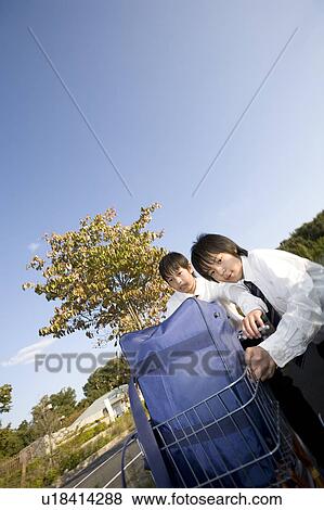 Stock Photo - Two schoolboys riding bicycle. Fotosearch