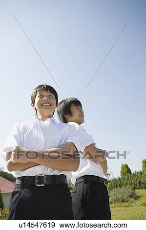 Two schoolboys standing View Large Photo Image Stock Photo - Two schoolboys standing. Fotosearch