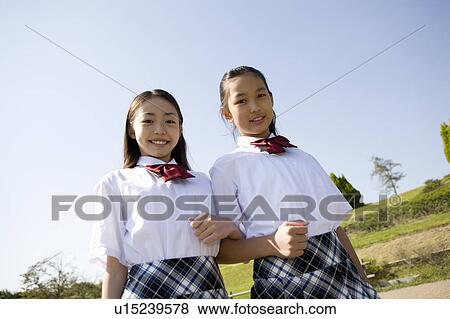 Stock Photo - Two schoolgirls standing. Fotosearch