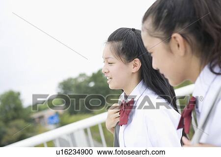 Two schoolgirls talking View Large Photo Image Stock Image - Two schoolgirls talking. Fotosearch