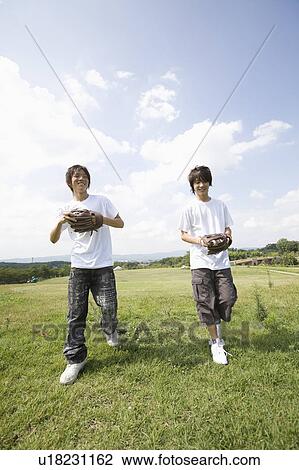 Two teenage boys playing catch View Large Photo Image Stock Image - Two teenage boys playing catch. Fotosearch