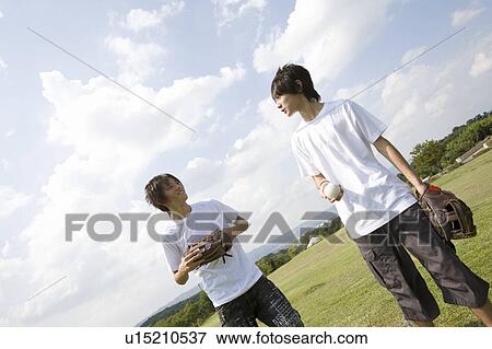 Two teenage boys playing catch View Large Photo Image Stock Photo - Two teenage boys playing catch. Fotosearch