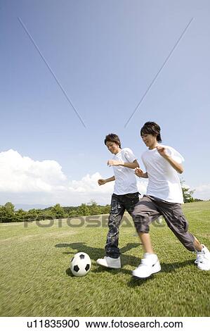 Two teenage boys playing soccer View Large Photo Image Stock Image - Two teenage boys playing soccer. Fotosearch