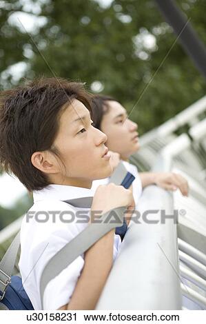 Two teenage boys standing View Large Photo Image Stock Image - Two teenage boys standing. Fotosearch