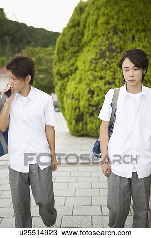 Two teenage boys walking View Large Photo Image Stock Image - Two teenage boys walking. Fotosearch