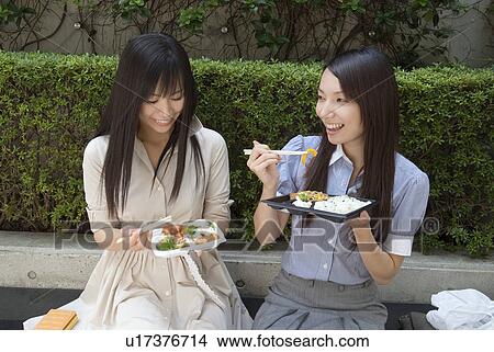 Two young women eating lunch View Large Photo Image Picture - Two young women eating lunch. Fotosearch