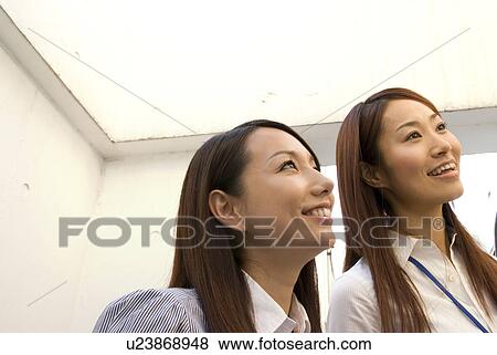 Stock Photo - Two young women smiling. Fotosearch