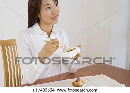 Young woman eating lunch View Large Photo Image Picture - Young woman eating lunch. Fotosearch