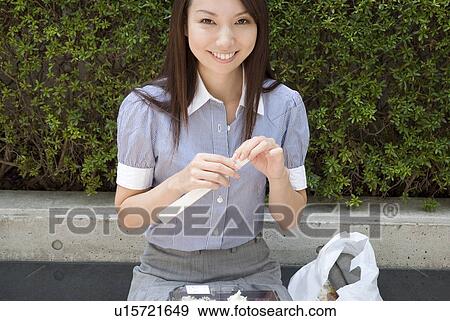 Young woman eating lunch View Large Photo Image Stock Photo - Young woman eating lunch. Fotosearch