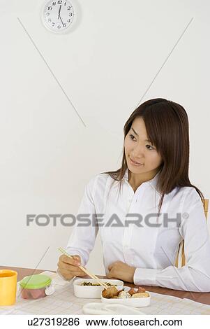 Young woman eating lunch View Large Photo Image Stock Photograph - Young woman eating lunch. Fotosearch